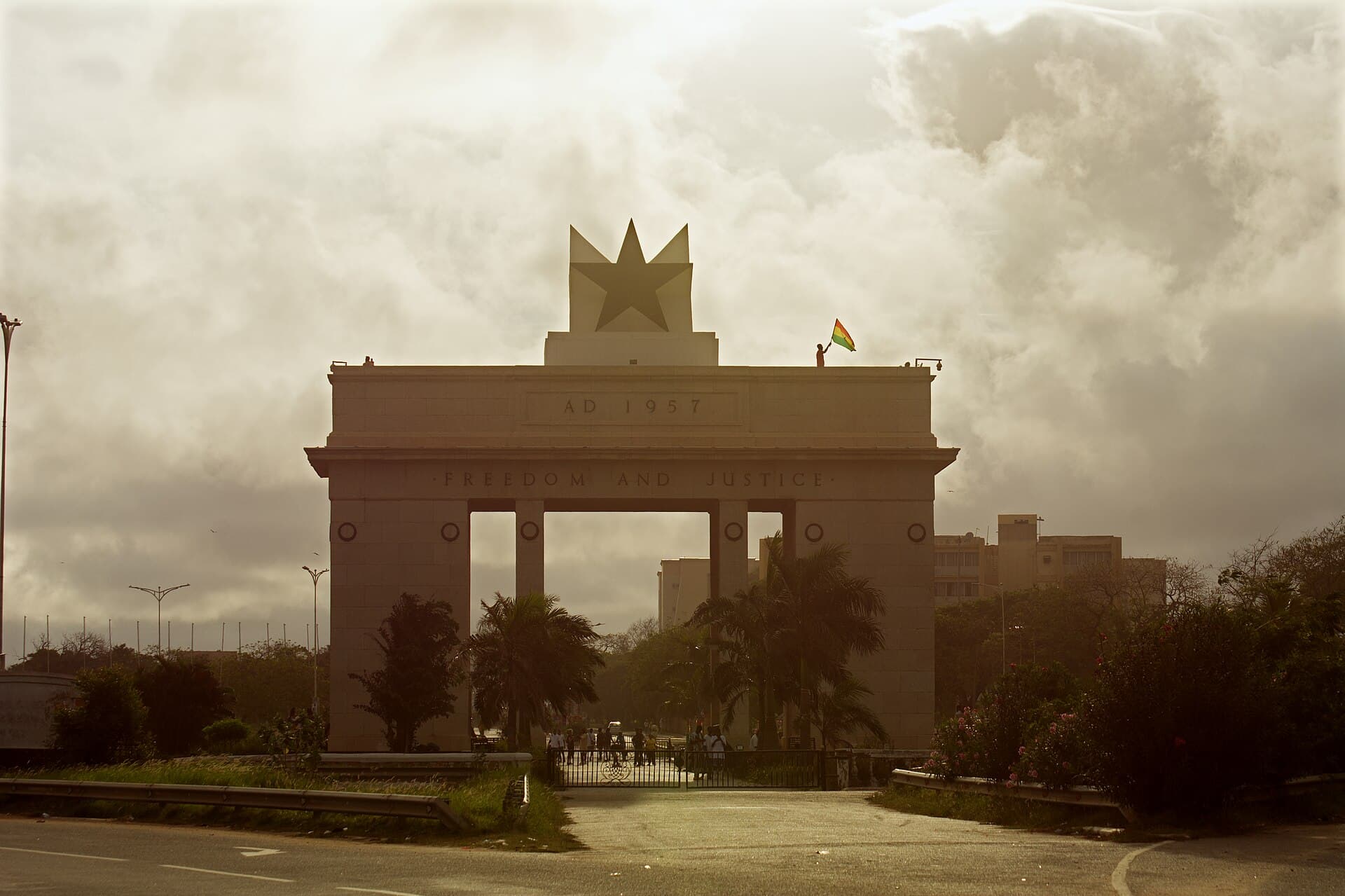 The Independence Arch in Accra, topped by a black star and inscribed AD 1957 and Freedom and Justice, with the Ghana flag flying beside it